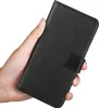 A hand holding a black flip-style phone case. Produktbild-Vorschau
