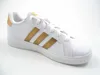 A white Adidas sneaker with gold stripes on a white background. Produktbild-Vorschau