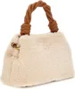 A beige fuzzy handbag with brown twisted leather handles and a gold ring detail on the side. Produktbild-Vorschau