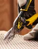 A close-up shot of hands wearing work gloves using tin snips to cut a piece of metal mesh. Anteprima dell’immagine prodotto