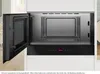 An open built-in microwave oven with its interior visible. Voir les images du produit