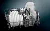 A close-up view of a dishwasher rack filled with clean dishes, cutlery, and pots. Produktbild-Vorschau