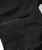 A close-up view of a black outdoor winter pant, showing a zippered pocket and a brand logo. Produktbild-Vorschau