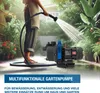 A person is using a garden pump to water plants in a garden. Produktbild-Vorschau