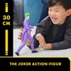 A young boy is playing with a Joker action figure on the floor. Anteprima dell’immagine prodotto