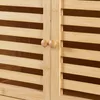 Close-up of a slatted wooden cabinet with two round knobs. Produktbild-Vorschau