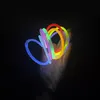 A hand holding several colorful glow sticks in the dark. Anteprima dell’immagine prodotto