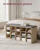 A storage bench with a cushion sits in front of a bed in a bedroom. Produktbild-Vorschau