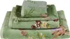 A stack of three green towels with a floral and berry pattern. Produktbild-Vorschau