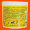 A close-up view of the back of a yellow tub of hand cream, showing product information and logos. Produktbild-Vorschau