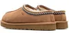 A pair of brown UGG slippers shown from a side-rear angle on a white background. Voir les images du produit