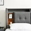 A close-up view of a bed headboard with integrated storage. Náhled obrázku produktu