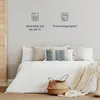 A bed with white bedding, pillows, and a woven basket. Produktbild-Vorschau