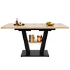 A rectangular dining table with a wood-grain finish and black legs, shown against a white background. The table has a shelf underneath and is decorated with a few items on top. Náhľad obrázku produktu
