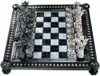 A chess set with intricately designed pieces on a checkered board. Podgląd zdjęcia produktu
