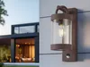 A modern house with a wall-mounted outdoor light fixture. Náhled obrázku produktu