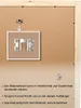 The back of a wooden picture frame with mounting hardware and instructions. Produktbild-Vorschau