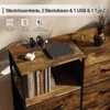 A close-up of a wooden side table with a power strip and a tablet charging, next to a larger wooden drawer unit. Náhľad obrázku produktu