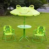 A frog-themed children's outdoor furniture set with a table and two chairs, placed on a grassy lawn. Produktbild-Vorschau