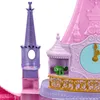 A close-up view of a toy castle with a clock face and a small green figurine. Podgląd zdjęcia produktu