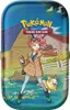 A tin box featuring a cartoon illustration of a woman and a dog in a rural setting, with the Pokemon Trading Card Game logo. Produktbild-Vorschau