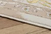 A close-up view of the edge of a rug on a wooden floor. Produktbild-Vorschau