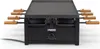 A black Princess raclette grill with wooden handles is shown from the front. Produktbild-Vorschau