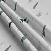 A close-up view of folded fabric with a winter-themed pattern. Produktbild-Vorschau
