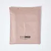 A folded beige textile product, likely a sheet or duvet cover, laid flat against a white wall. Náhled obrázku produktu