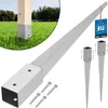 A product shot of metal ground post anchors and a wooden post with a metal sleeve, set against a grassy background. Náhled obrázku produktu