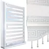 A close-up view of a white and silver roller blind with a Greek key pattern, shown partially rolled up. Produktbild-Vorschau