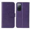 A purple flip phone case with a floral and butterfly embossed design is shown, with the case open and closed. Produktbild-Vorschau