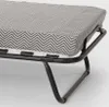 Close-up view of a folding bed frame with a mattress covered in a chevron pattern. Produktbild-Vorschau