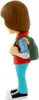 A side view of a stylized figurine of a young boy wearing a backpack. Podgląd zdjęcia produktu