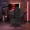 A gaming setup with a chair, computer, and monitor in a dimly lit room with red and yellow lighting. Produktbild-Vorschau