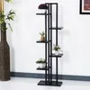 A black multi-tiered plant stand with several potted plants on it, placed against a white wall. Anteprima dell’immagine prodotto