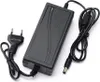 A black power adapter with two cables and a European plug, shown on a white background. Produktbild-Vorschau