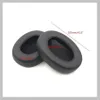 Two black ear pads for headphones are shown on a white and light gray background. Produktbild-Vorschau