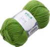 A ball of green yarn with a label. Podgląd zdjęcia produktu