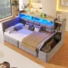 A modern bedroom with a grey upholstered sofa bed featuring built-in storage and LED lighting. Produktbild-Vorschau