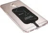 A close-up shot of a smartphone with a wireless charging adapter attached to its back. Náhľad obrázku produktu
