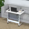 A white adjustable height table with a laptop, mouse, and coffee cup on it, placed next to a gray sofa. Produktbild-Vorschau
