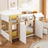 A children's loft bed with a house-like design, featuring two doors, shelves, and a ladder, set in a bedroom. Voir les images du produit