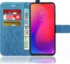 A blue flip phone case with card slots and a phone inside. Produktbild-Vorschau
