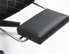 A close-up view of a black footrest attached to a chair. Produktbild-Vorschau