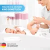 A mother changing her baby on a changing table. Podgląd zdjęcia produktu