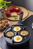A frying pan with eggs cooking in it, surrounded by ingredients like tomatoes, peppers, and eggs. Voir les images du produit