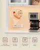A close-up view of a power strip with a coffee maker in the background, highlighting its features. Produktbild-Vorschau