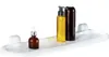 A white shelf with three bottles of toiletries on it. Náhled obrázku produktu