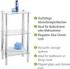 A three-tiered glass shelf unit with chrome legs, displayed with bathroom accessories on the shelves. Produktbild-Vorschau